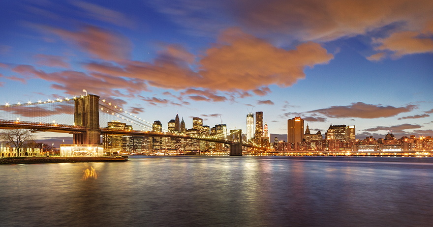 view of brooklyn bridge and skyline at dusk
